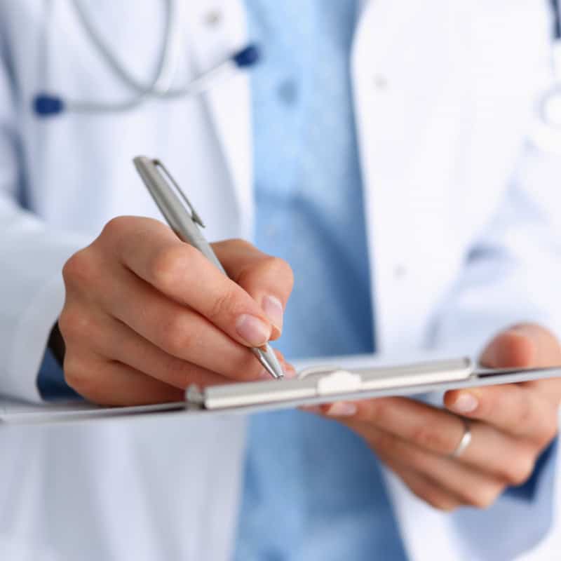 Female Doctor Arm Hold Silver Pen And Pad During