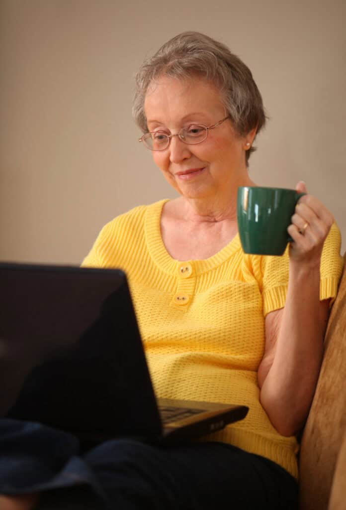 Happy Senior Looking At Computer